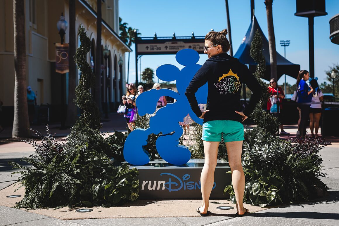 Woman at RunDisney Expo wearing a Chase your dreams princess zip up hoodie. Part of the article 