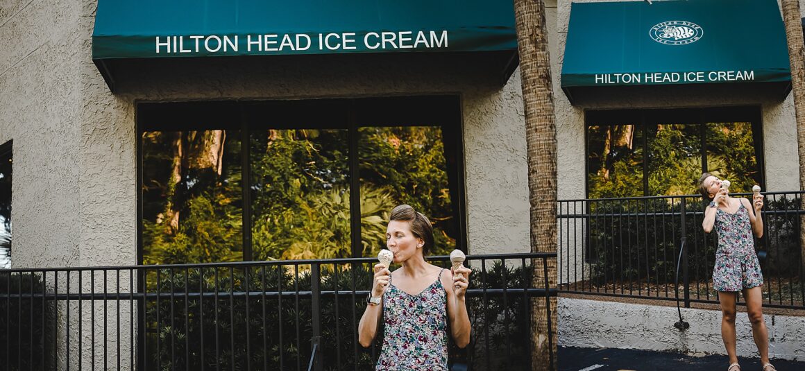Hilton head ice cream shop. Woman eating two ice cream cones to cool off on a hot day. Article on 7 Tips for Running in High Humidity Weather
